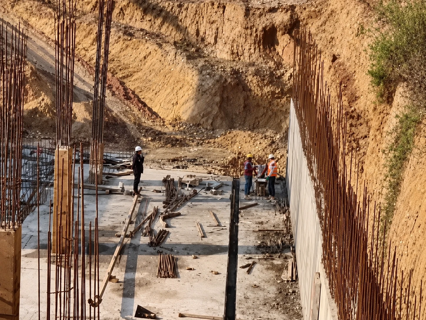 AI-enhanced construction image showing basement slab work and retaining-wall reinforcement
